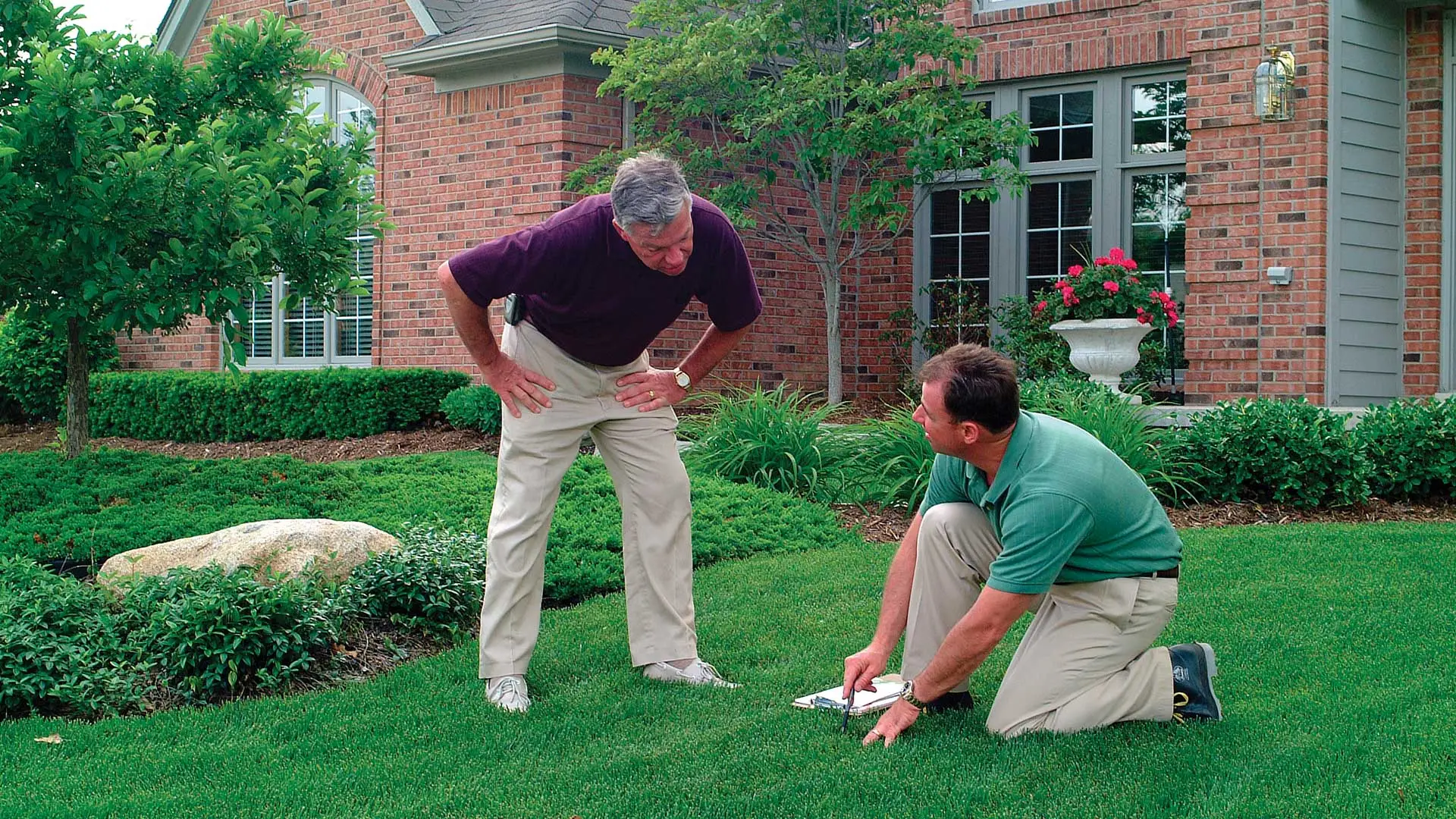 The Lawn Techs discussing a lawn treatment program with a customer in Berkeley Heights, NJ.